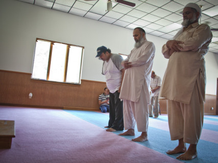 (Far right) Muhhamad Shafiq and (center) Hazem Hassan pray during 1:30 prayer at the Islamic Society of Greater Kansas City on Tuesday afternoon, June 26, 2012.  RNS photo by Sally Morrow