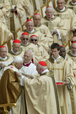 In a symbolic moment during the two-hour Mass officially installing Pope Benedict XVI, Cardinal Jorge Medina Estevez of Chile places a pallium around Benedict's neck. The pallium, a woolen stole, is a symbol of the mission of the pastor, who like the good shepherd, must lead the lost sheep of humanity out of the desert, the new pope said.  Photo by Grzegorz Galazka.