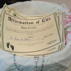 The Rev. Frank Pavone of the anti-abortion group Priests for Life dedicated a basket of naming certificates for 47 babies who died in the Philadelphia clinic of Dr. Kermit Gosnell. RNS photo courtesy Andre Kim/Priests for Life.