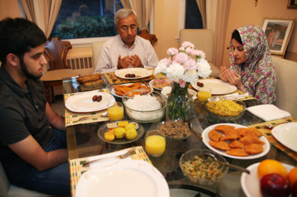  Imran, 22, and his parents Habeeb and Seemi Ahmed pray in their Long Island, NY home just before breaking their fast after the first day of Ramadan on Aug. 11, 2010. RNS photo by Sally Morrow