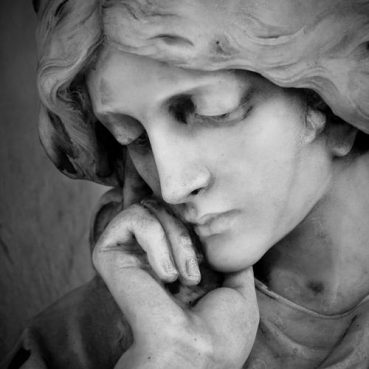 Sculpture of a woman looking down